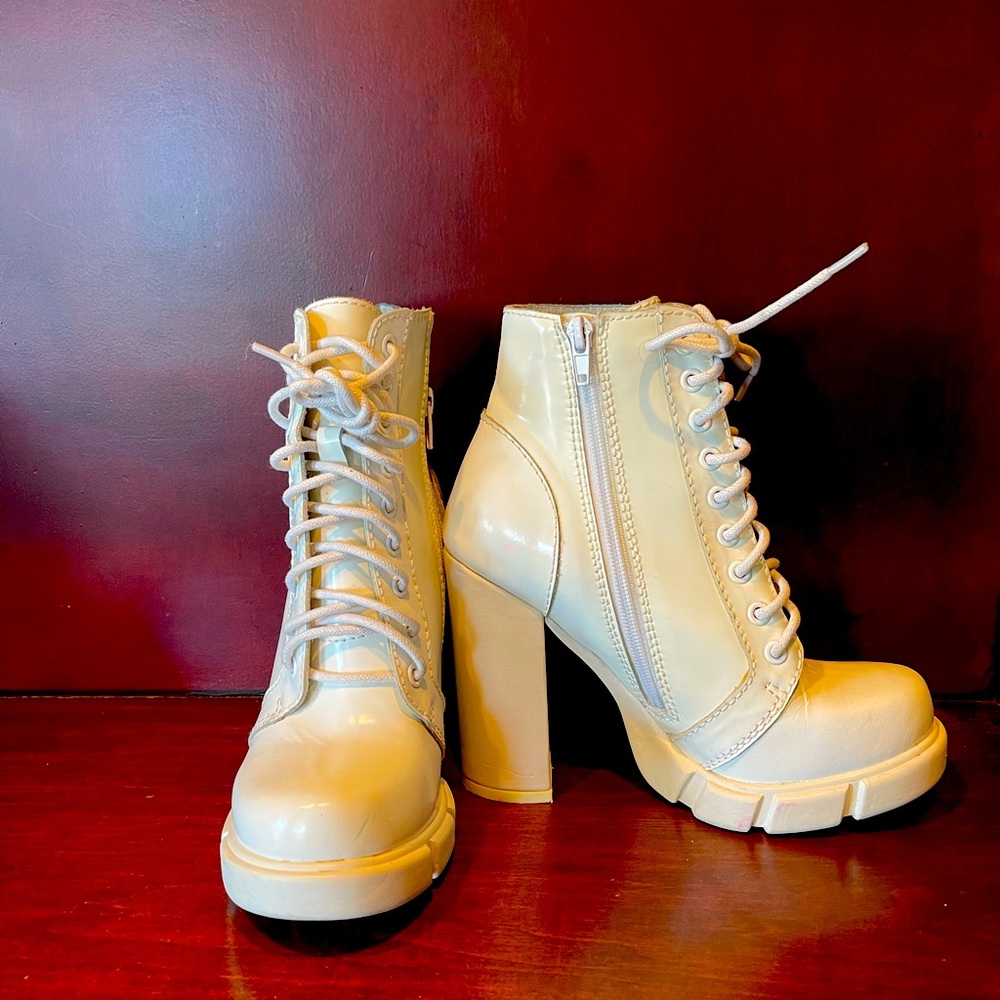 White Jeffrey Campbell patent leather heeled ankle boot.
